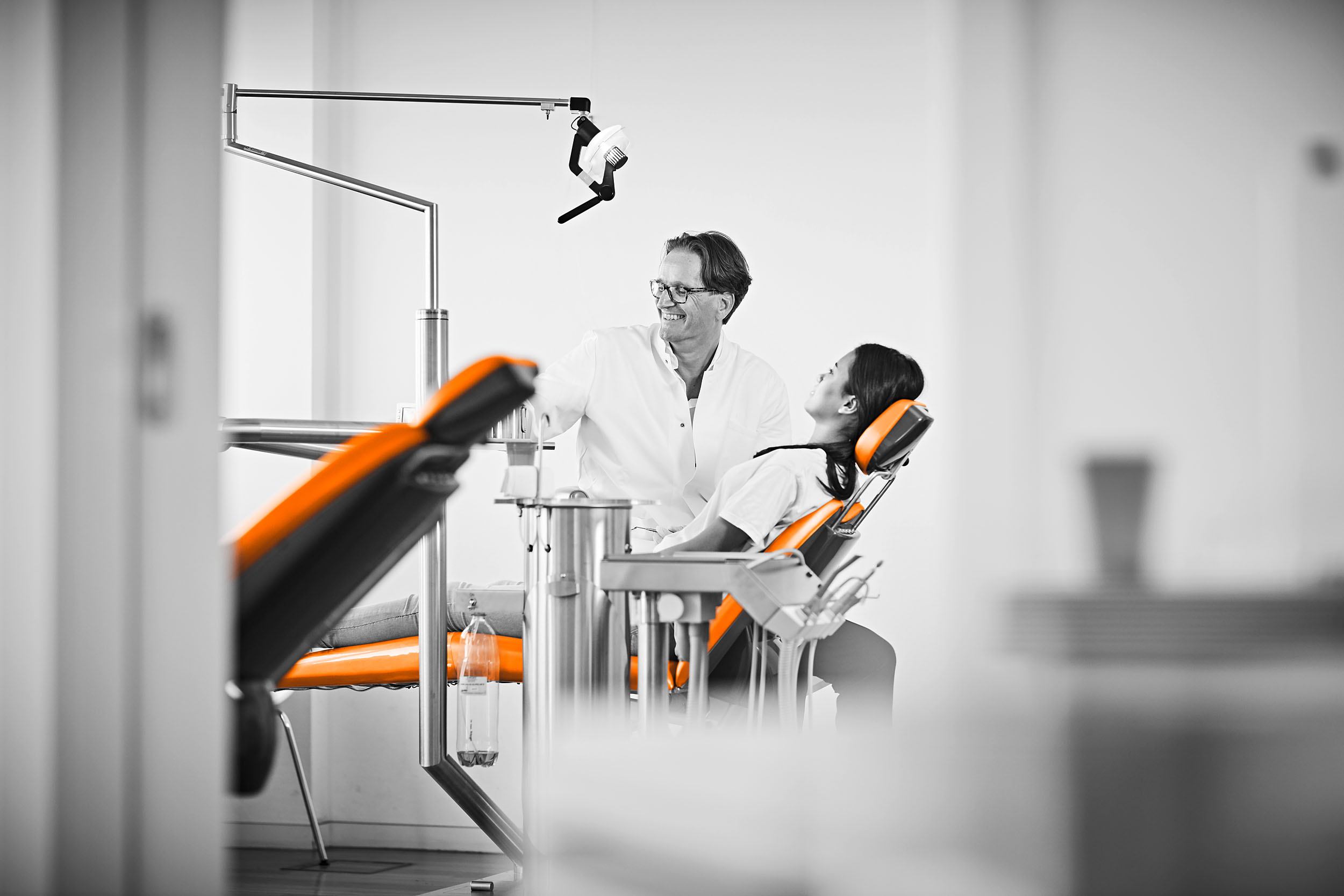 Dr. Ritter lacht mit einer jungen Patientin auf dem Behandlungsstuhl und nimmt ihr so die Angst
